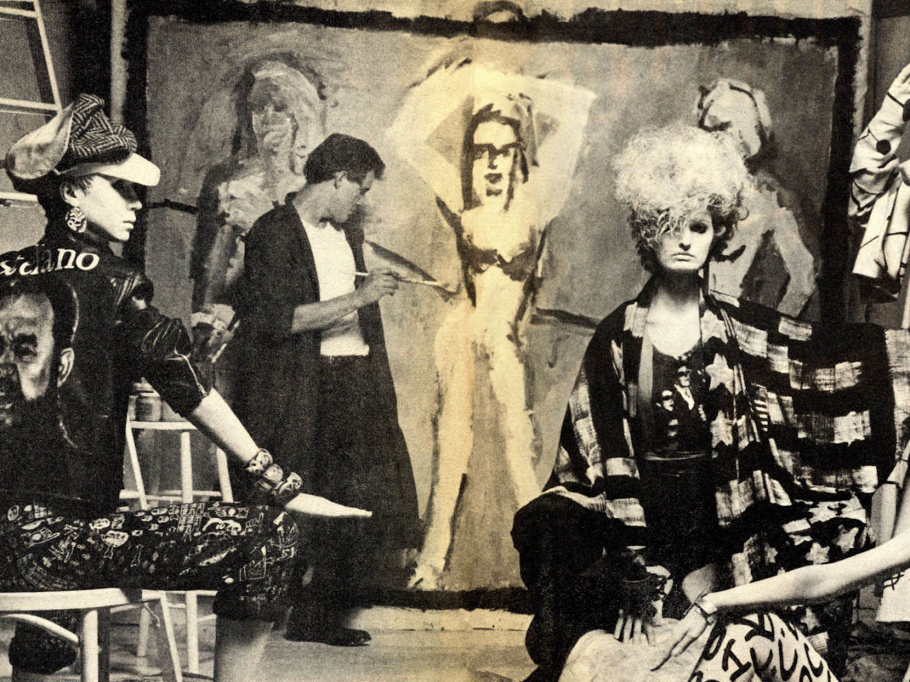 A still from the film Make Me Famous. A group of artists look at a painting.